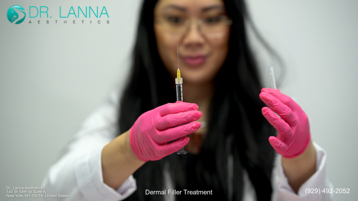 Dr. Lanna holding a syringe filled with filler